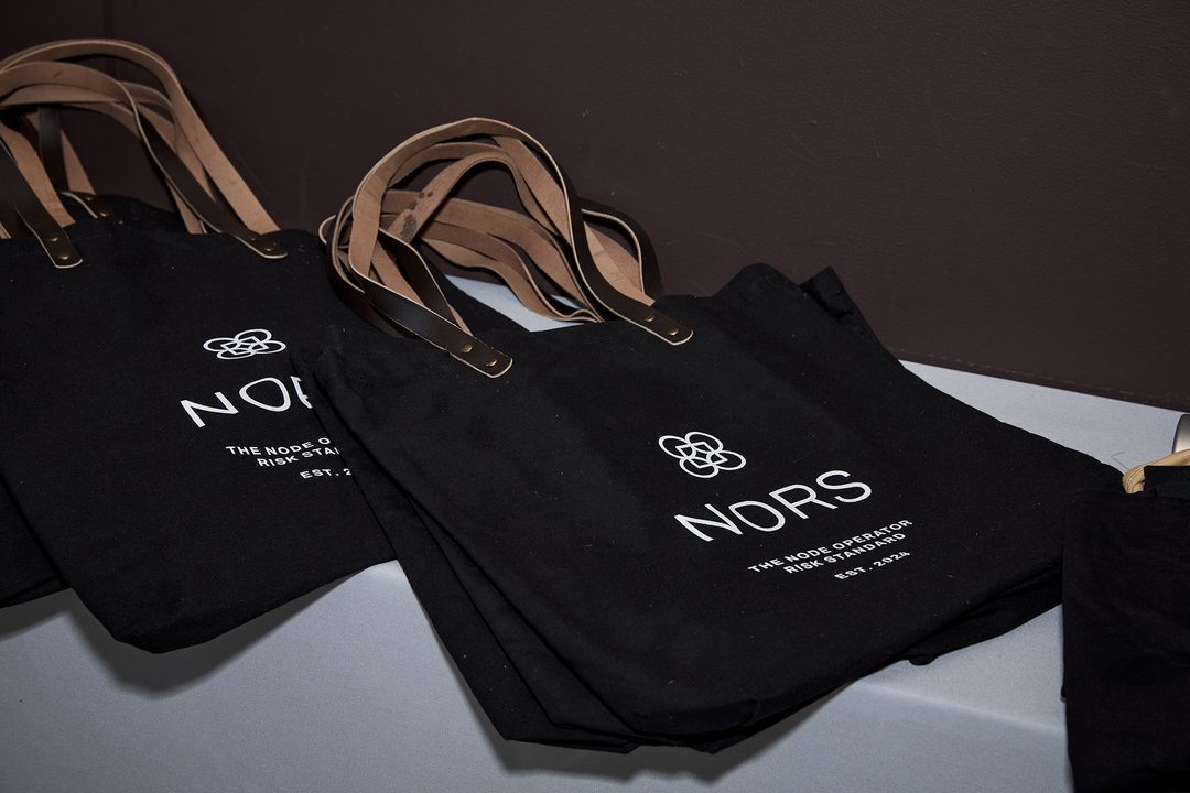 Black canvas NORS tote bags with leather handles at the launch event