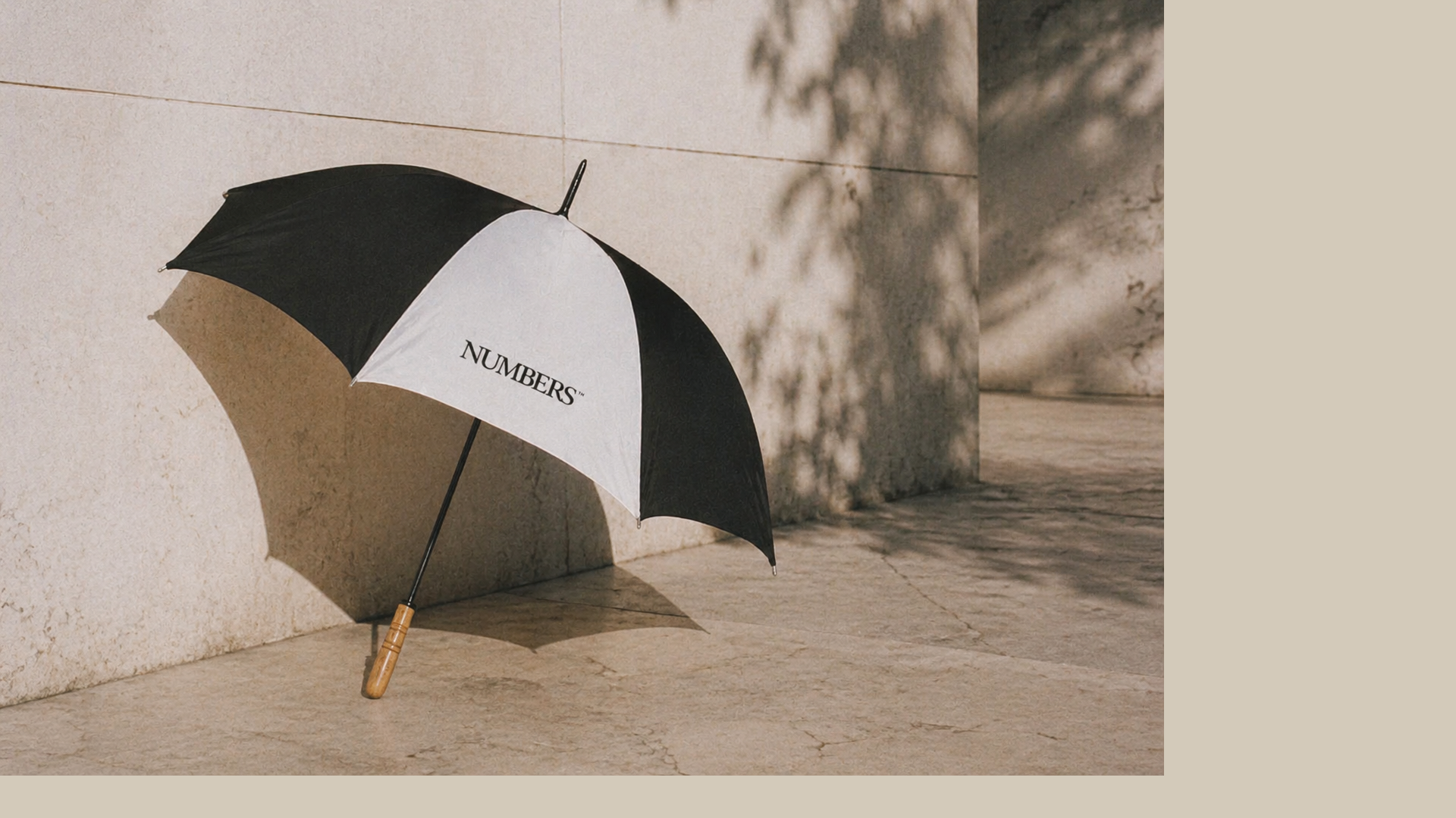 Numbers serif wordmark on a black-and-white golf umbrella